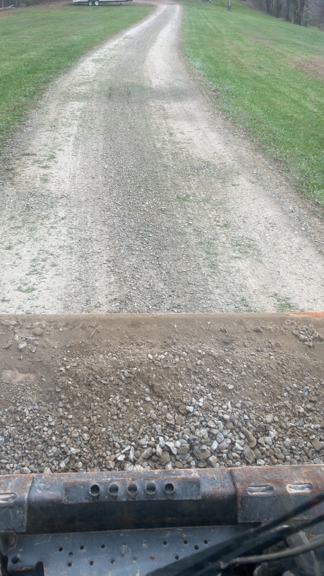 Flooded residential driveway with standing water and drainage problems in Ohio Valley requiring professional regrading and excavation work