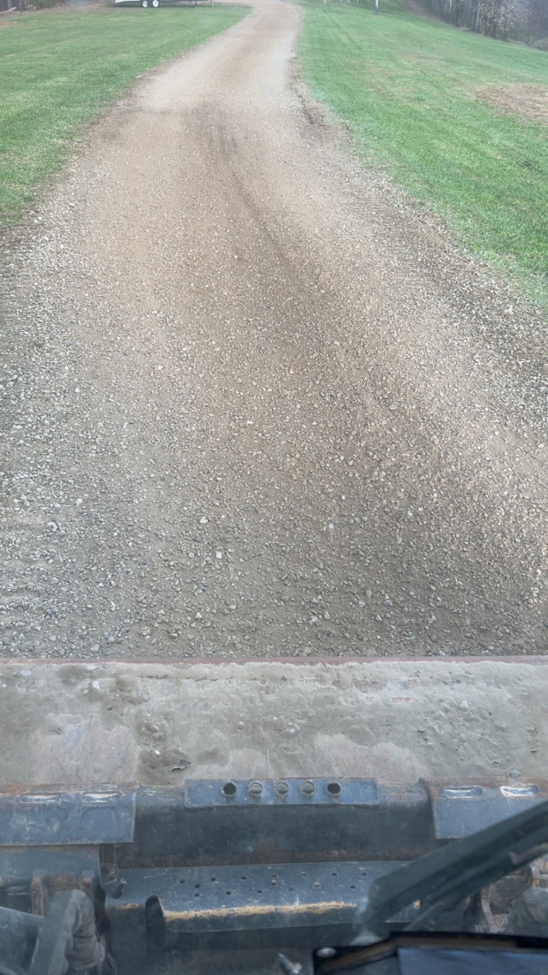 Before and after driveway regrading showing improved drainage and proper water flow away from home in Marietta Ohio